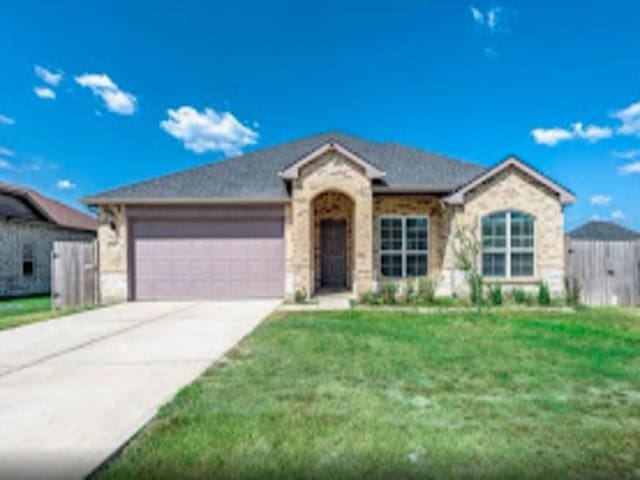 view of front facade featuring a garage and a front lawn