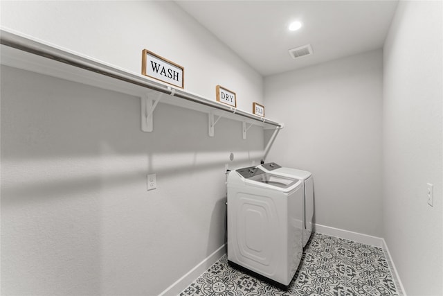 clothes washing area with washing machine and clothes dryer