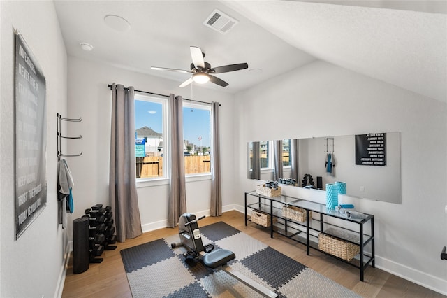 exercise area featuring hardwood / wood-style floors, plenty of natural light, ceiling fan, and vaulted ceiling