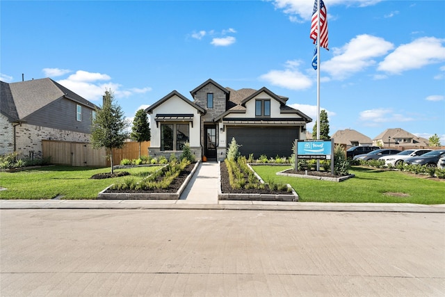 view of front of property with a garage and a front yard