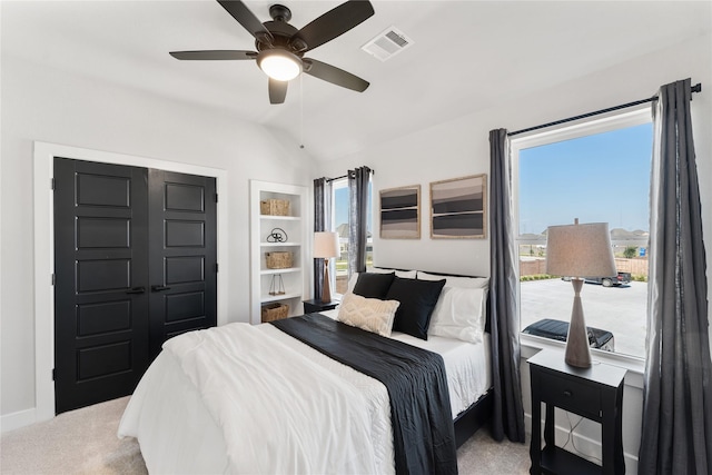 carpeted bedroom featuring vaulted ceiling and ceiling fan