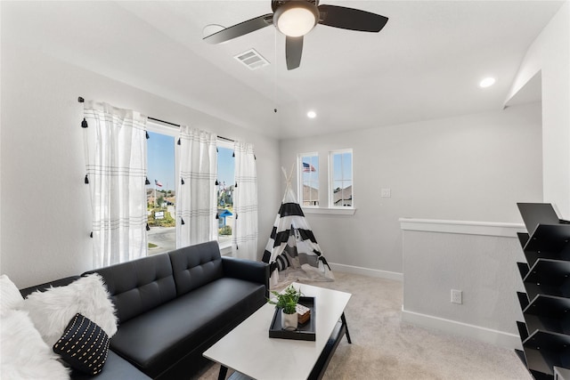 carpeted living room featuring ceiling fan