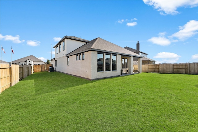 back of house with a lawn