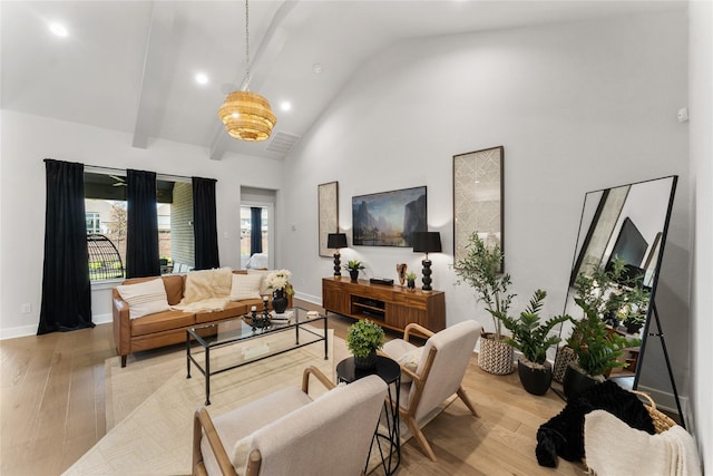 living room featuring a chandelier, beamed ceiling, high vaulted ceiling, and light hardwood / wood-style floors