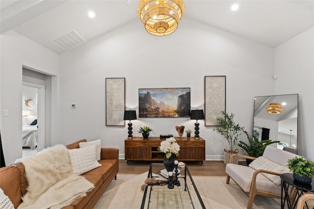 living room featuring high vaulted ceiling and light hardwood / wood-style flooring