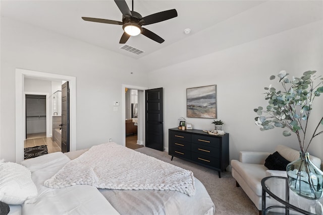 bedroom with light carpet, ceiling fan, a spacious closet, a closet, and lofted ceiling