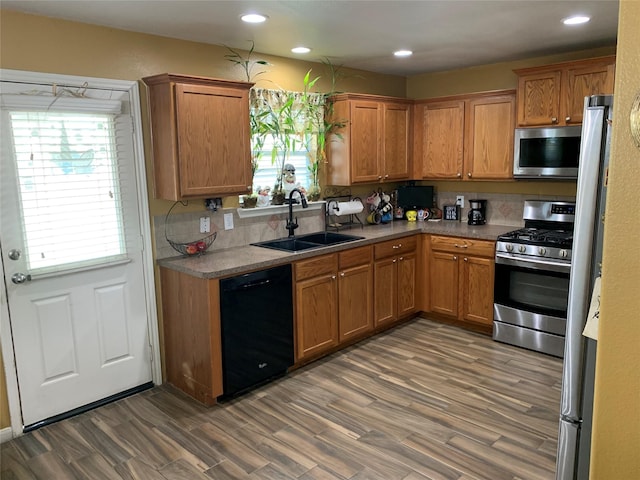 kitchen featuring sink, appliances with stainless steel finishes, and dark wood-type flooring