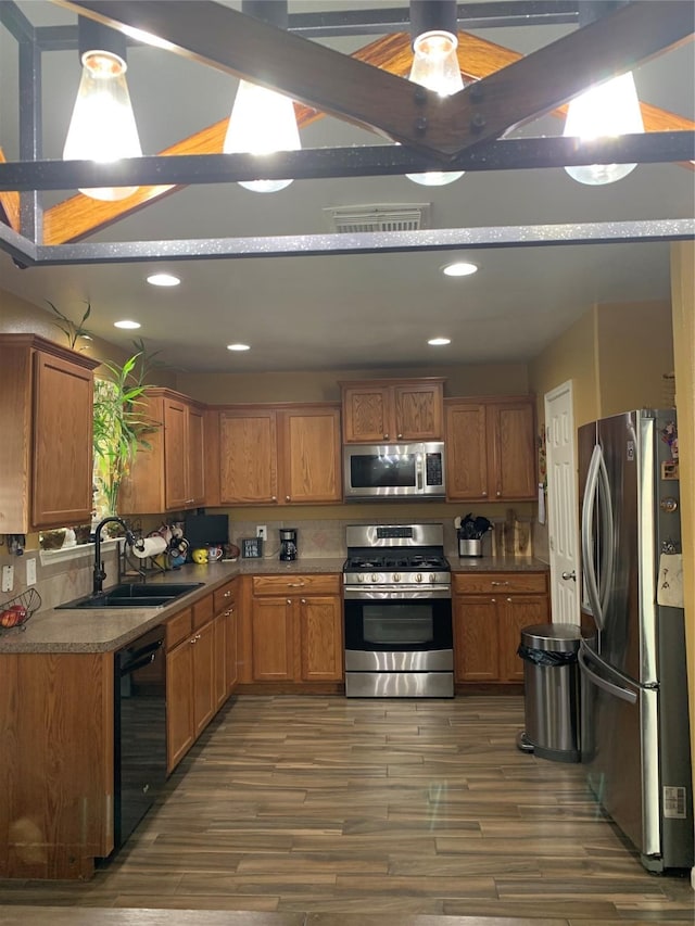 kitchen with decorative backsplash, sink, dark hardwood / wood-style floors, and appliances with stainless steel finishes