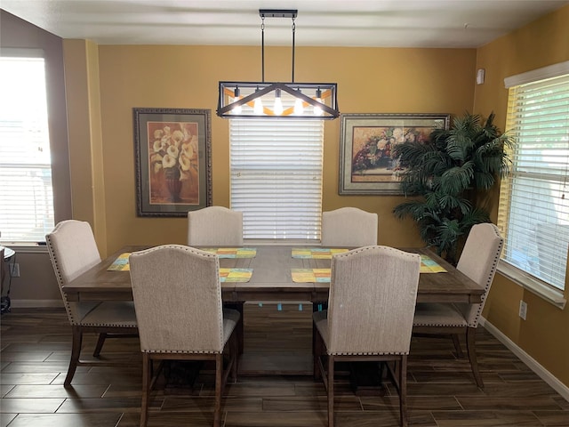 dining space featuring dark hardwood / wood-style flooring and a healthy amount of sunlight