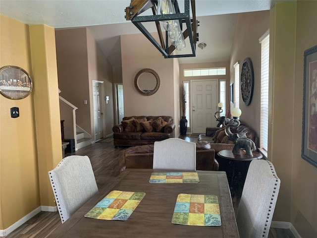 dining space featuring a chandelier and dark wood-type flooring