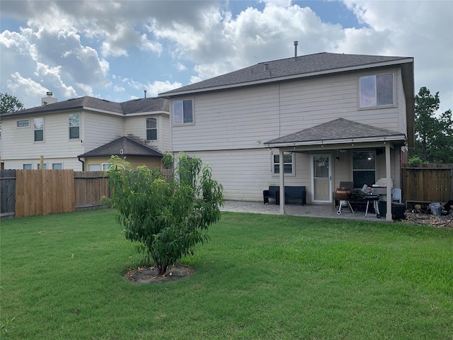 back of property with a lawn and a patio