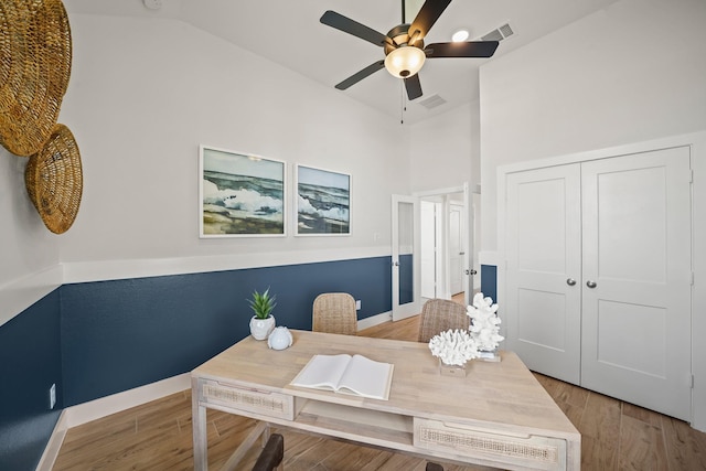 home office with hardwood / wood-style floors, ceiling fan, and lofted ceiling