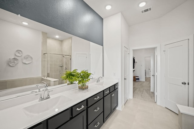 bathroom featuring tile patterned floors, vanity, shower with separate bathtub, and a high ceiling