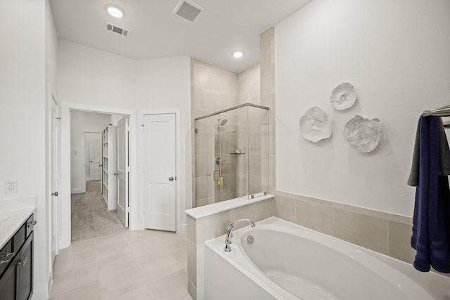 bathroom with tile patterned floors, vanity, and independent shower and bath