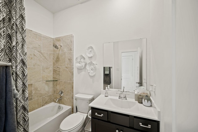 full bathroom featuring vanity, toilet, and tiled shower / bath