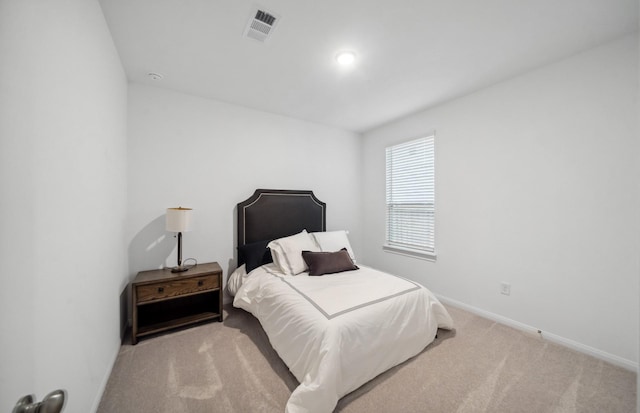 bedroom with light colored carpet