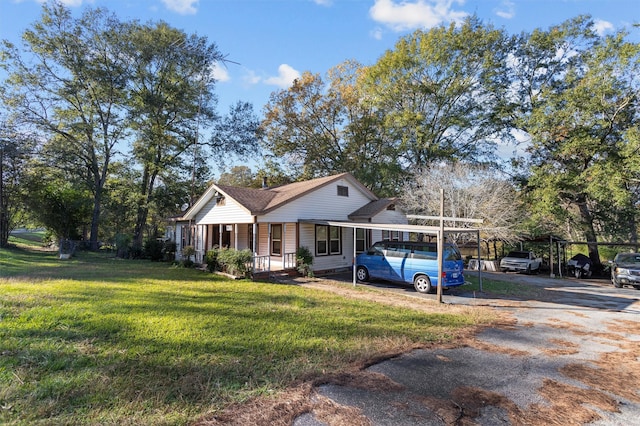 view of front of property with a front lawn, a porch, and a carport