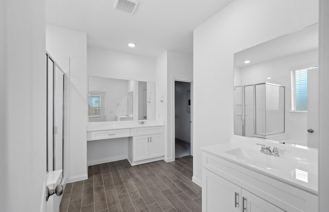 bathroom featuring vanity and an enclosed shower