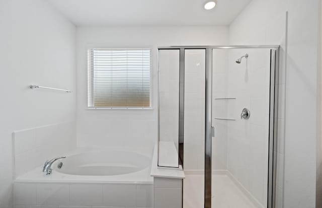 bathroom featuring shower with separate bathtub