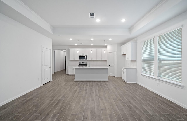 unfurnished living room with ornamental molding, sink, light wood-type flooring, and a tray ceiling