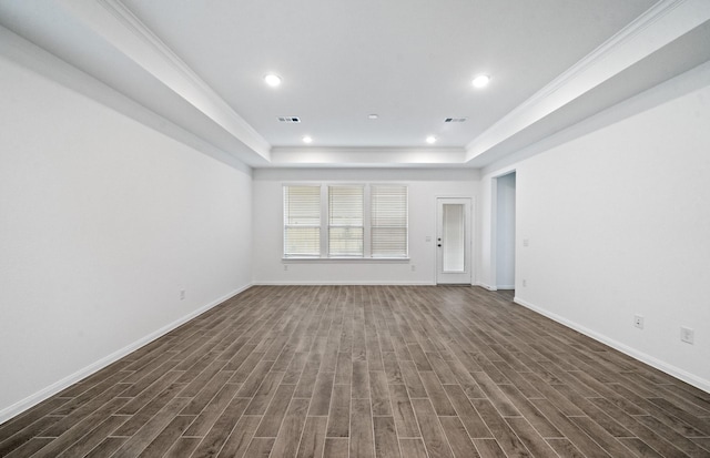 unfurnished living room with a tray ceiling and dark hardwood / wood-style floors