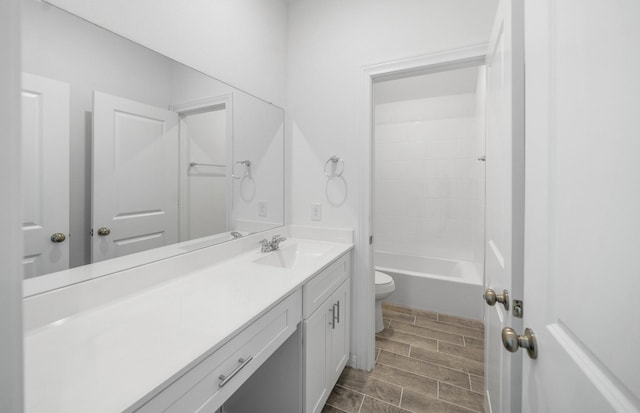 full bath with shower / bathing tub combination, wood finish floors, vanity, and toilet