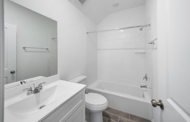 bathroom with lofted ceiling, toilet, visible vents, vanity, and tub / shower combination