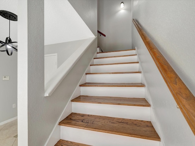 stairway with tile patterned flooring