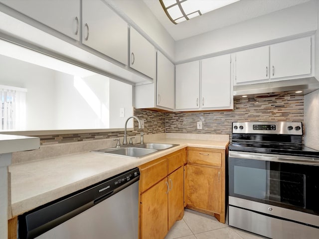 kitchen featuring white cabinetry, sink, stainless steel appliances, tasteful backsplash, and light tile patterned floors