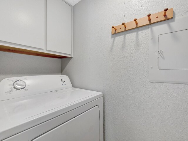 laundry area featuring cabinets, washer / dryer, and electric panel