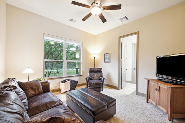 carpeted living room with ceiling fan