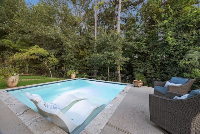 view of swimming pool with a patio