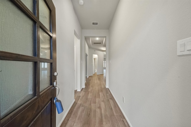 hall with light hardwood / wood-style flooring