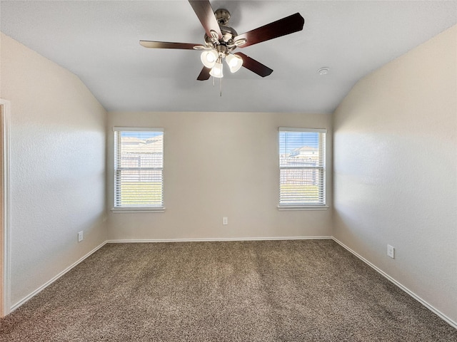 empty room featuring carpet flooring, plenty of natural light, and lofted ceiling