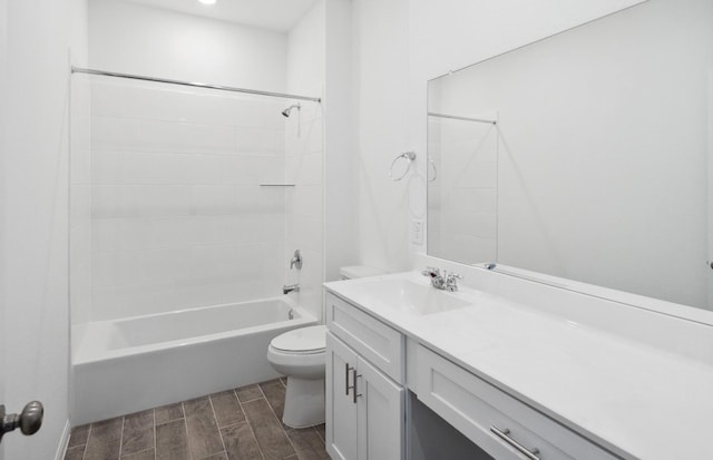 bathroom featuring toilet, wood tiled floor, tub / shower combination, and vanity