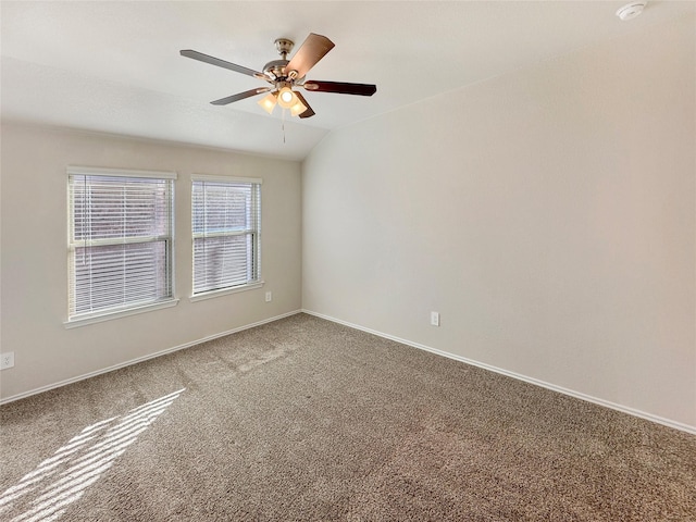 unfurnished room with carpet floors, vaulted ceiling, and ceiling fan