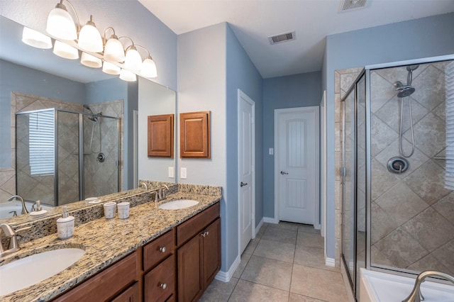 bathroom with tile patterned floors, vanity, and walk in shower