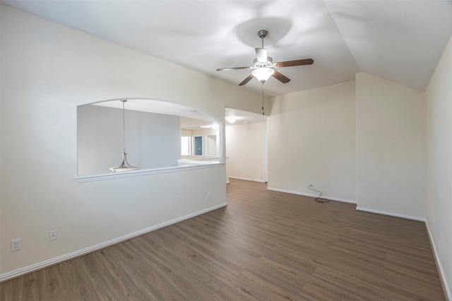 spare room with ceiling fan, dark hardwood / wood-style flooring, and lofted ceiling