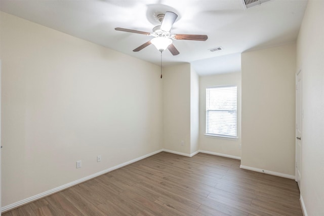 spare room featuring ceiling fan and hardwood / wood-style flooring