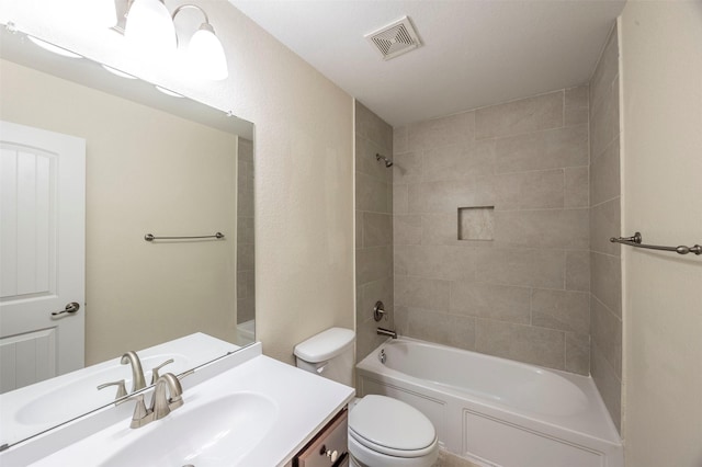 full bathroom with vanity, toilet, and tiled shower / bath