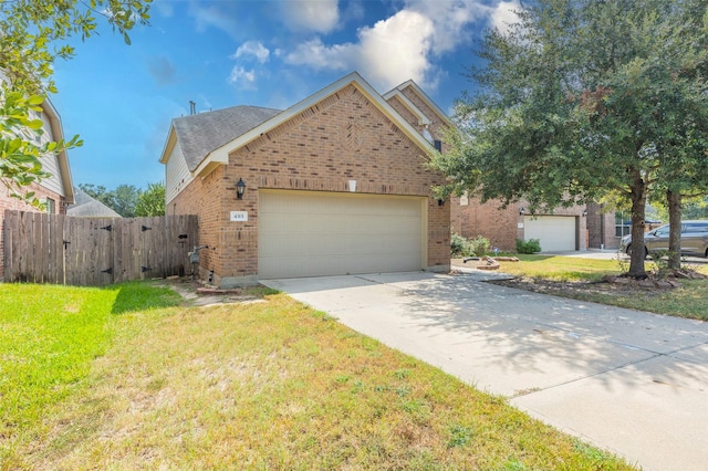 view of front of property with a front lawn and a garage