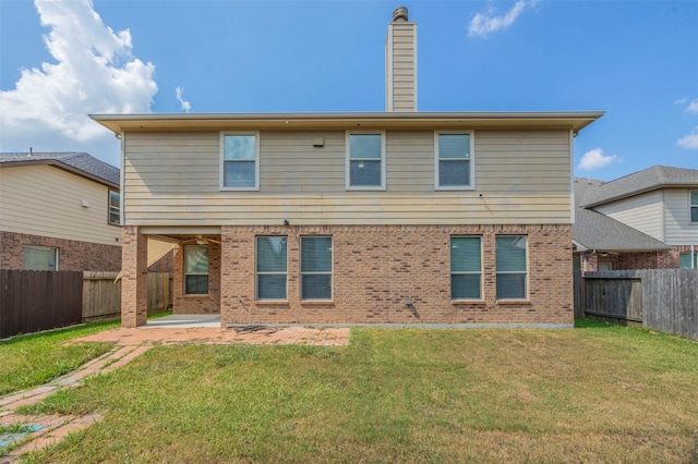 rear view of house with a patio area and a yard