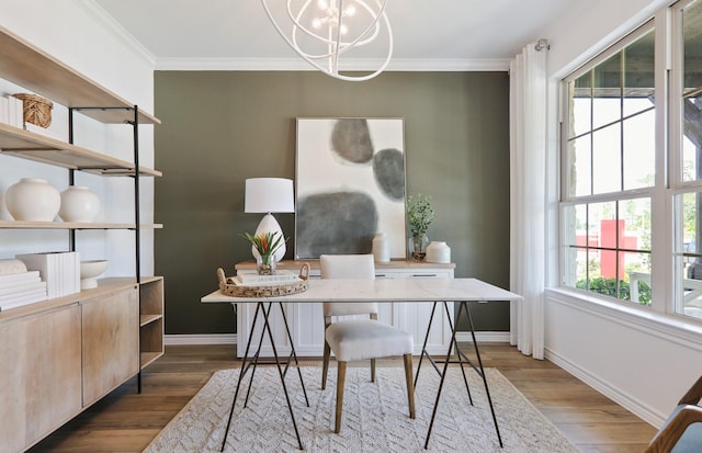 home office with plenty of natural light, dark hardwood / wood-style floors, ornamental molding, and a chandelier