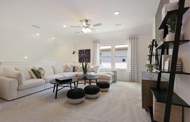 carpeted living room with ceiling fan and lofted ceiling