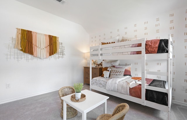 carpeted bedroom with lofted ceiling