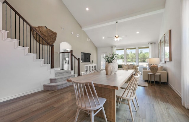 dining space featuring hardwood / wood-style flooring, ceiling fan, beam ceiling, and high vaulted ceiling