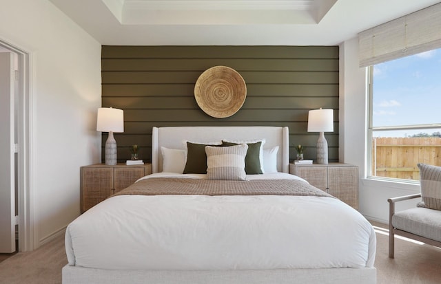 carpeted bedroom with a tray ceiling