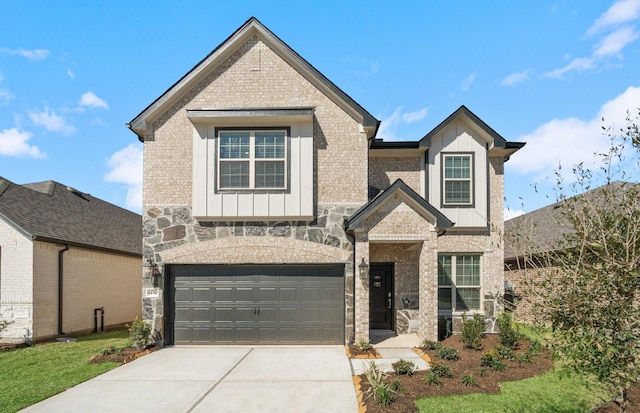 view of front of home featuring board and batten siding, brick siding, driveway, and an attached garage