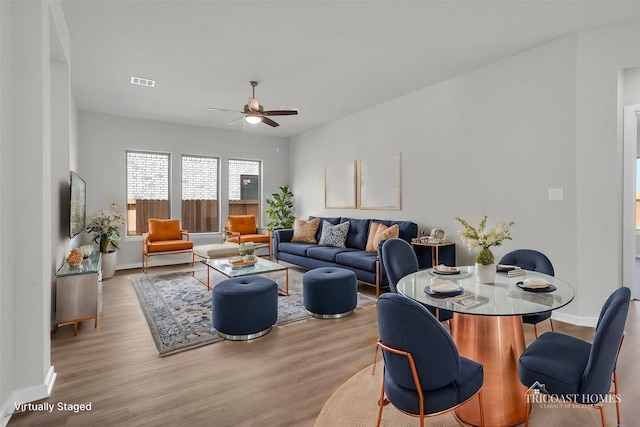 living room featuring ceiling fan and light hardwood / wood-style floors