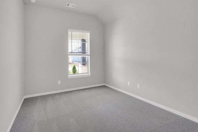 spare room with lofted ceiling and carpet floors